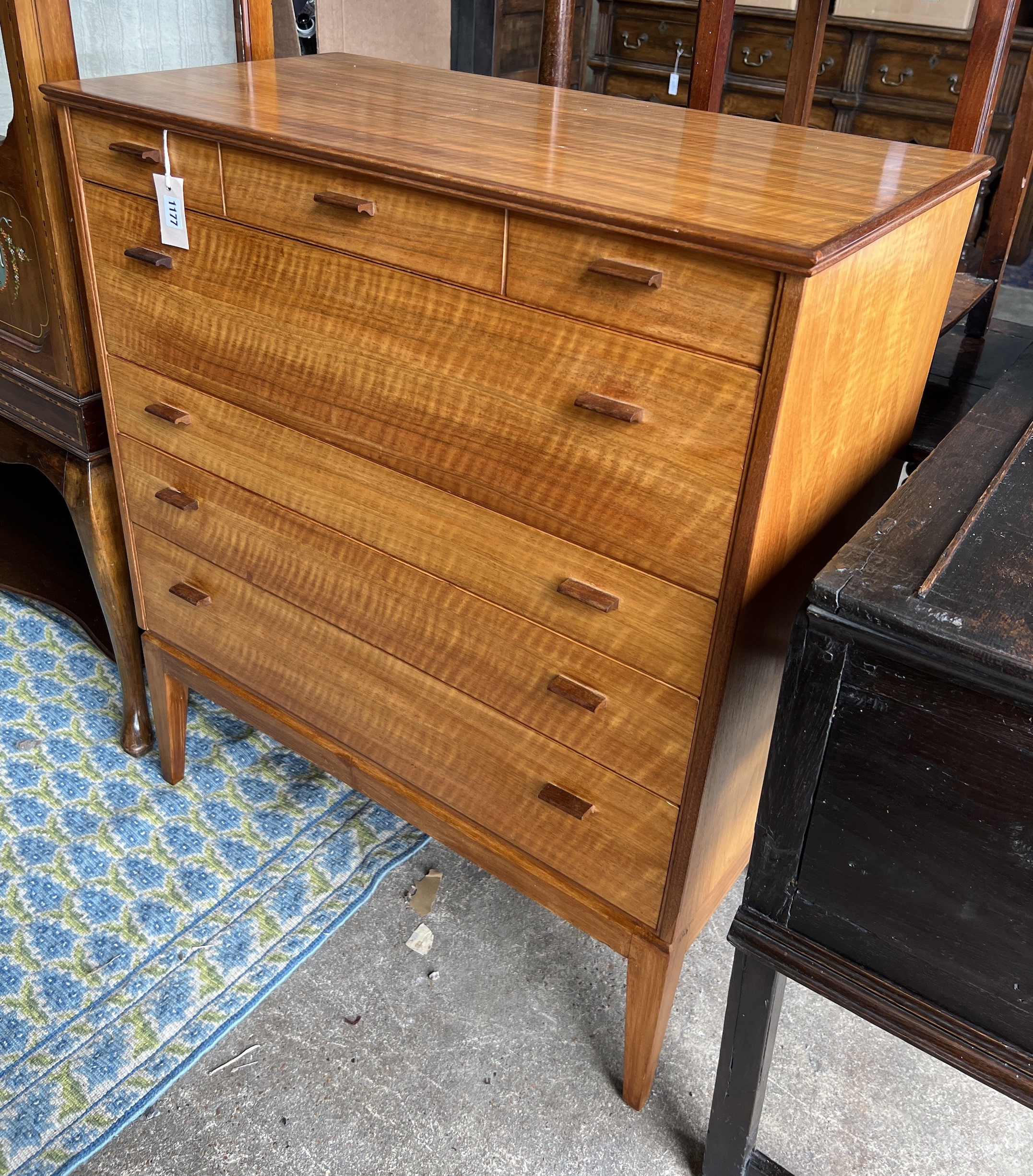Attributed to Alfred Cox for Heals. A mid century walnut five drawer chest, width 85cm, depth 44cm, height 99cm